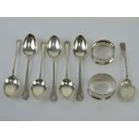 A set of six hallmarked silver teaspoons together with a jam spoon and a napkin ring each