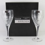 A boxed presentation pair of lead crystal wine glasses each standing 21cm high.