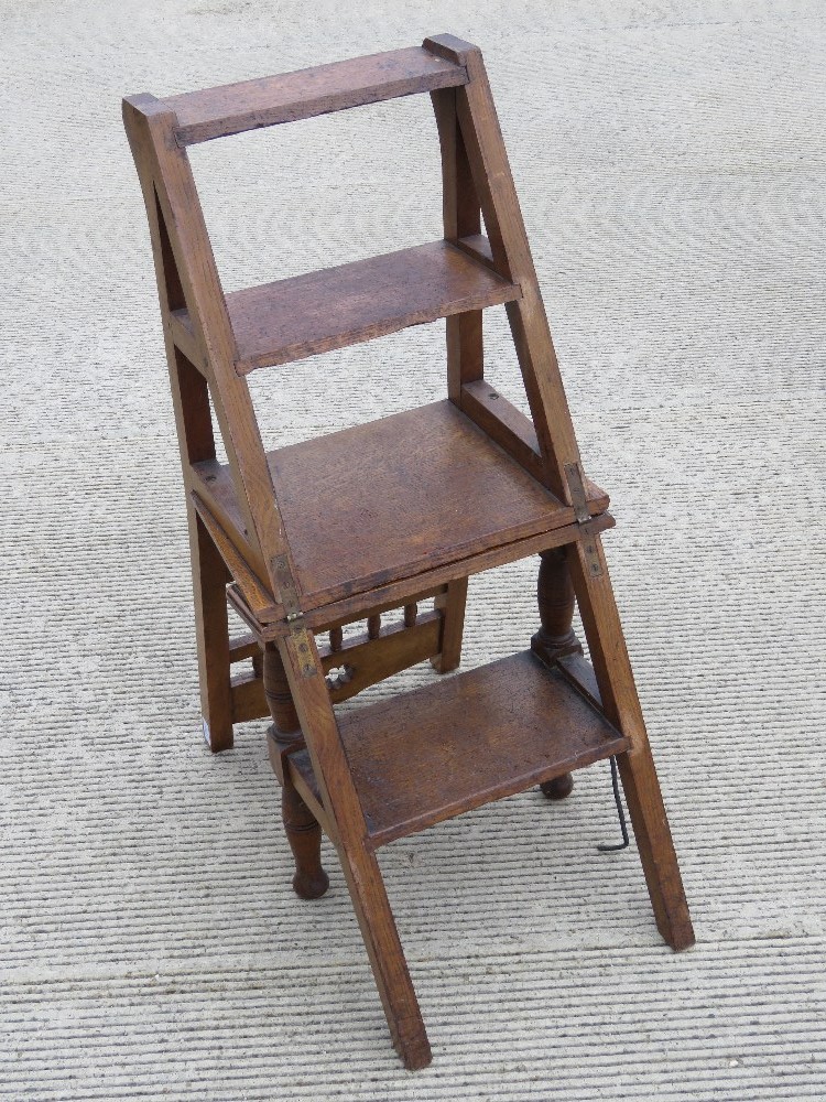 A single oak metamorphic set of library steps folding to form a chair. Height of seat is 44cm.