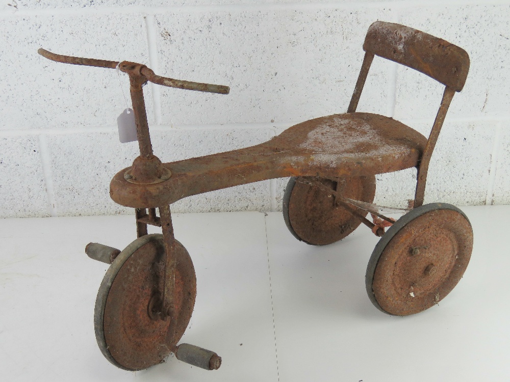 A vintage child's tricycle in unrestored condition approx 64cm in length.