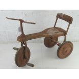 A vintage child's tricycle in unrestored condition approx 64cm in length.