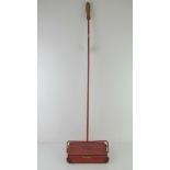 A vintage Green Arrow carpet sweeper.