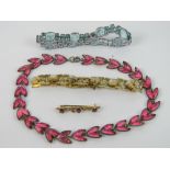 A vintage 9ct gold bar brooch set with three pink oval cut stones, slightly a/f, marked 375, 1.4g.