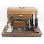 A vintage sewing machine having floral decoration and mother or pearl inlay,