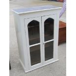 A Victorian two door glazed and painted hanging bookcase doors opening to reveal shelves within,