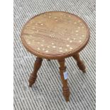 A single inlaid Indo Asian side table raised over four turned legs profusely decorated with brass