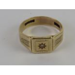 A 9ct gold signet ring having star set single diamond to centre, hallmarked 375, size S, 4.3g.