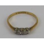 A vintage three stone illusion set diamond ring, 18ct gold and platinum setting, size L, 1.6g.