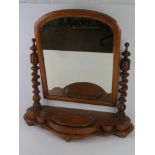 A large mahogany Victorian bedroom mirror raised over barleytwist supports upon the shaped base