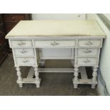 A kneehole desk comprising central drawer flanked by further drawers to each side,