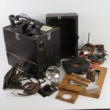 A vintage projector in original case, together with a box of 'photographic enlarging' equipment.