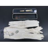 An antique expanding glove box opening to reveal bone glove stretchers,