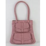 A baby pink handbag having double pocket design to front approx 31cm wide.