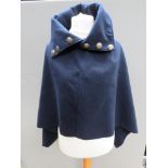 A 5% wool Italian navy coloured shawl/cape having crest type buttons upon.