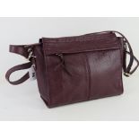 A plum coloured leather handbag by M&S, approx 24cm wide.