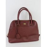 A burgundy leather handbag by Storm London, approx 35cm wide.