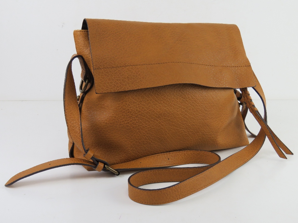 A mustard coloured cross body bag by M&S, slight wear noted to corners, approx 33cm wide.