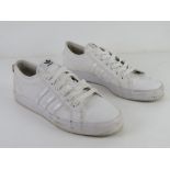 A pair of size 11 men's white trainers.