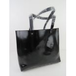 A black plasticised tote bag by Givenchy Paris approx 31cm wide.