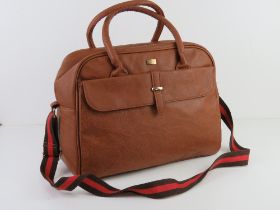 A tan coloured overnight bag having canvas shoulder strap by Storm London, approx 38cm wide.