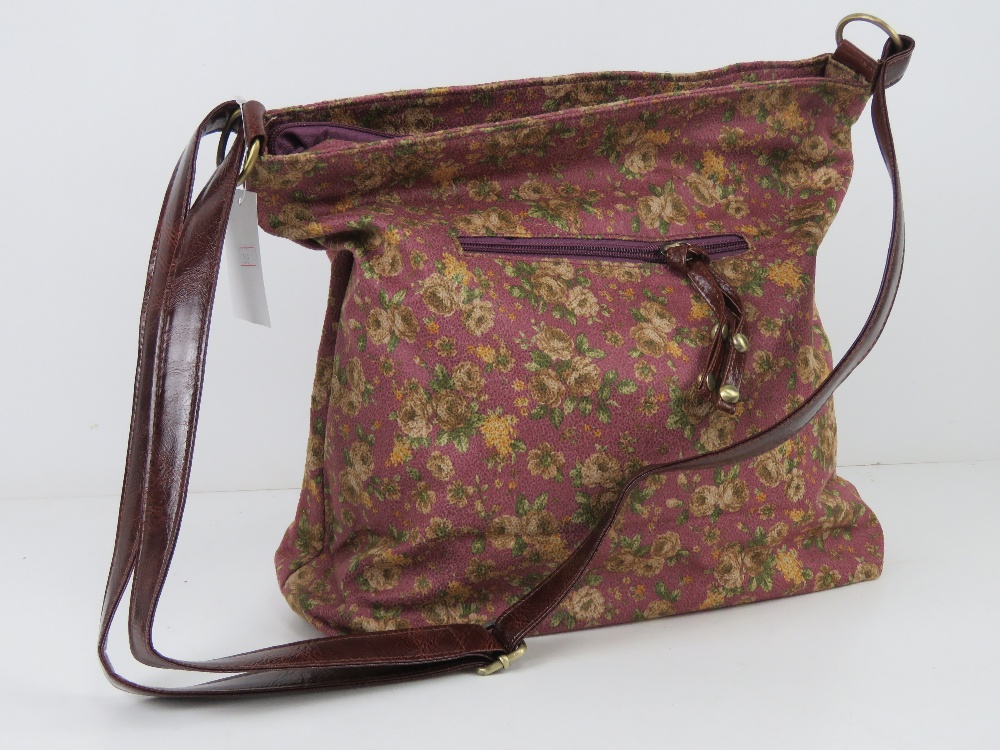An 'as new' fabric tote bag having floral pattern on purple background 34 x 30cm.