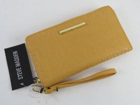 A yellow Steve Madden wallet having original labels upon RRP $48.