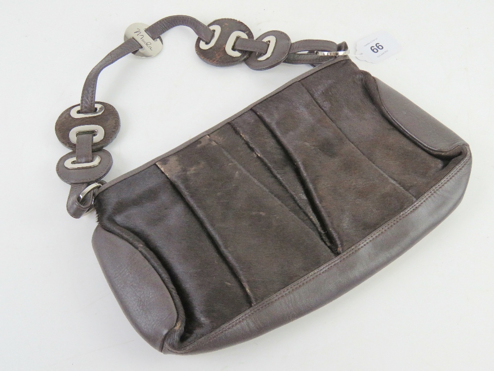 A brown cow hide and leather handbag by Fiorelli, approx 32cm wide.