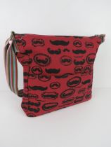 A fabric tote bag having mustache pattern in red 'as new', approx 38 x 34cm.