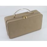 An Estee Lauder makeup case having lucite type plasticised handle approx 33cm wide.