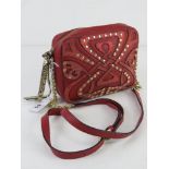 A vintage shoulder bag by Biba in red leather approx 18cm wide.