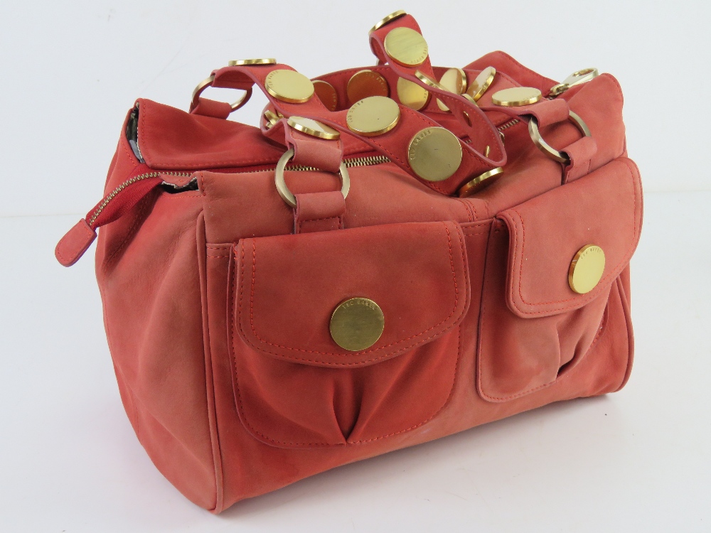 Ted Baker; a coral suede handbag having floral lining, approx 30cm wide.