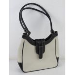 A white and black leather handbag by Joshua Taylor approx 25cm wide.