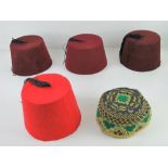 Four vintage fez hats. Together with another embroidered cap.