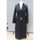 A black felted woolen ladies coat having velvet collar, labels removed,