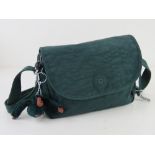A green canvas cross body bag by Kipling having key chain upon, approx 23.5cm wide.