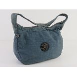 A blue canvas Kipling bag approx 27cm wide.