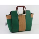 A contemporary green and tan handbag having lucite type plasticised handles, approx 29cm wide.