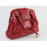 Jasper Conran; a red leather handbag having three sectional compartment approx 37cm wide.