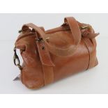 A tan leather handbag approx 30cm wide.