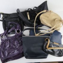A black Top Shop tote bag together with a quantity of other handbags.
