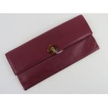 A vintage Jane Shilton purple leather clutch bag having original invoice for Howell's of Cardiff