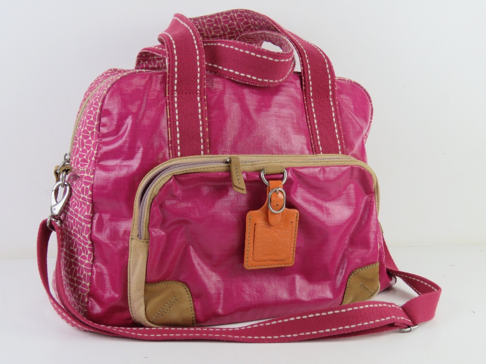 A hot pink 'Key-Per' overnight bag by Fossil approx 42cm wide.