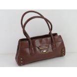 A brown leather handbag by Fiorelli approx 34cm wide.