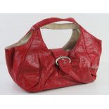 A red patent handbag by River Island approx 35cm wide.