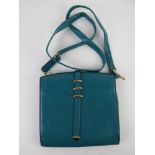 A turquoise shoulder bag by Bella approx 22cm wide.