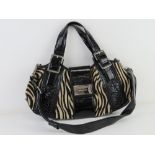 Karen Millen; faux zebra skin and black patent handbag approx 40cm wide.