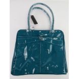 A teal patent overnight bag by Storm London approx 38cm wide having original labels upon.
