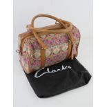 A Liberty pattern fabric and leather handbag by Clarks with original dust bag, approx 32cm wide.