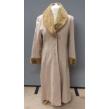 A wool and cashmere coat by Berghaus, size 14, having faux fur collar and cuffs,