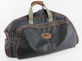 A navy and brown leather holdall type suitcase approx 62 x 27cm. Some wear noted.